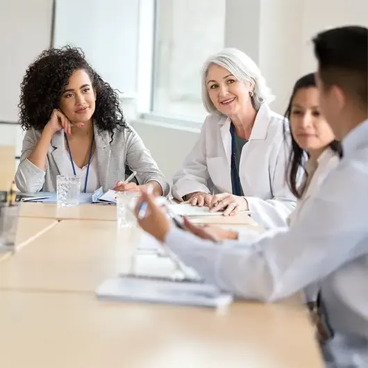 Healthcare administrator meeting with staff